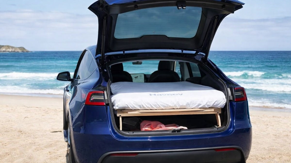 Tesla Model Y set up to camp on a beach